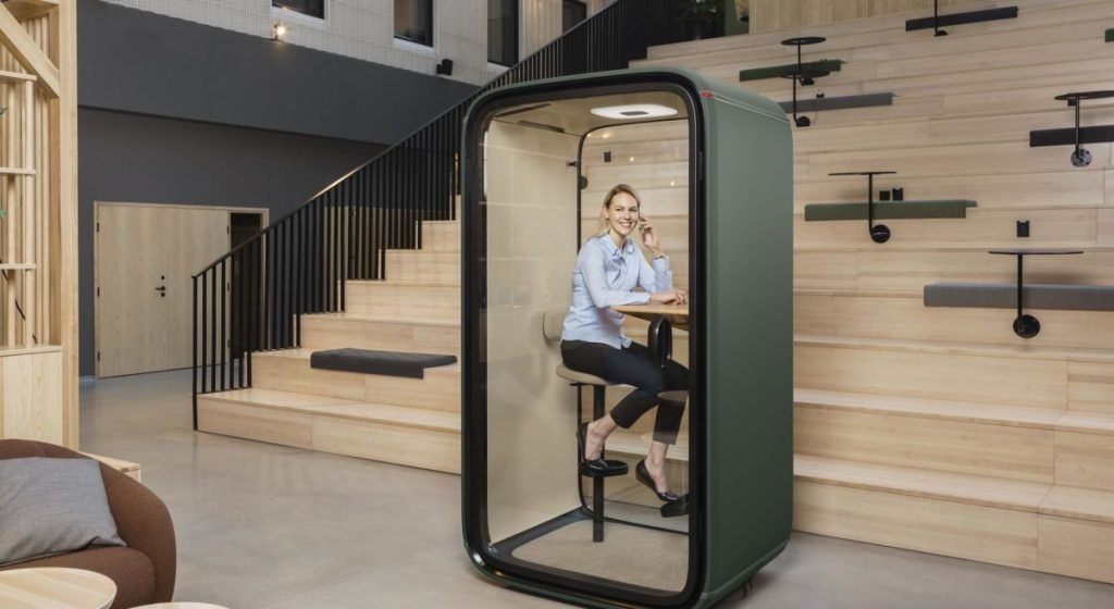 lady talking on phone inside a booth